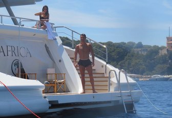 Cristiano Ronaldo stands on swim platform of charter yacht next to girlfriend Georgina Rodriguez