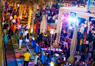 busy streets with open-air bars and restaurants in Abu Dhabi 