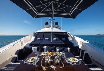 dining area and sunpads on foredeck of charter yacht Take 5