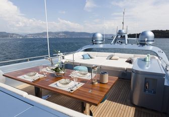 Table and sunpad area on deck of superyacht 55 FIFTYFIVE