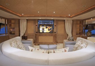 curved sofa and TV in the skylounge aboard motor yacht JO