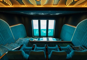 Interior teal-colored cinema onboard charter yacht KISMET