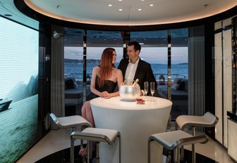 guests enjoy champagne at the bar on board motor yacht MYSKY