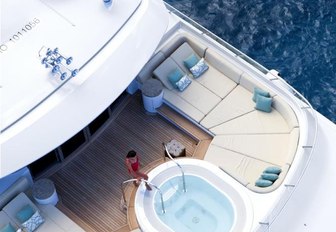 A charter guest enjoys the Jacuzzi on board superyacht Lady Britt