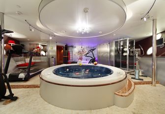 A treadmill and Jacuzzi inside of luxury yacht SHERAKHAN