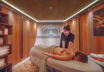 Charter yacht MALTESE FALCON massage room with charter guest on table
