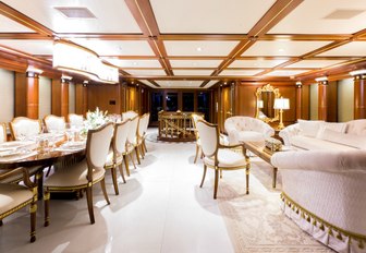 opulent main salon with dining table and sofas on board motor yacht My Seanna