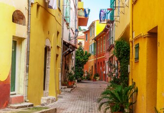 colourful house either side cobbled alley in france