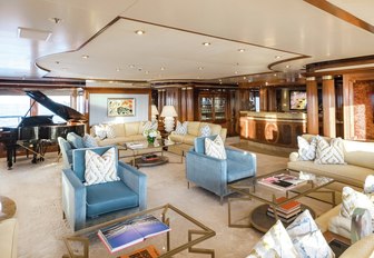 comfortable seating area and grand piano in the skylounge aboard motor yacht TITANIA 