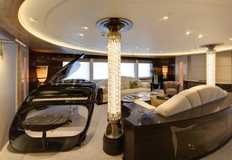 A sleek black grand piano in the main salon of superyacht AMARYLLIS