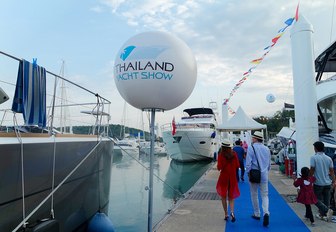 walking along the boardwalks at the Thailand Yacht Show in Ao Po Grand Marina, Phuket