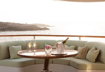 Table with champagne on luxury yacht St David, and views overlooking the sea