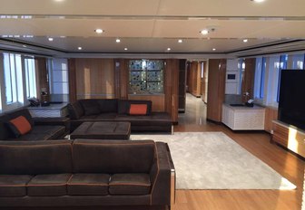 plush leather sofas and widescreen TV in the main salon aboard luxury yacht Code 8