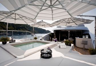 spa pool surrounded by sun pads on the aft part of the sundeck aboard motor yacht 11/11 