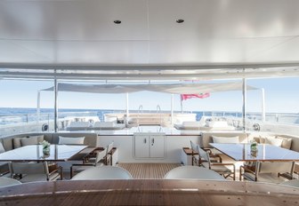 alfresco dining with pool beyond on the main deck aft of motor yacht Grace E