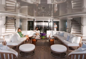 charter guests sit on comfortable sofas on the aft deck of luxury yacht Lady E 