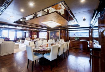 the bnanquet style dining arangment located forward in the main salon of charter yacht BASH