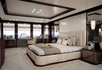 large bed in the classically-styled master suite aboard motor yacht Spectre