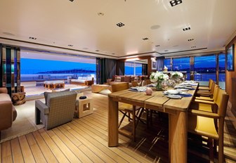 teak-floored dining area on board superyacht Planet Nine