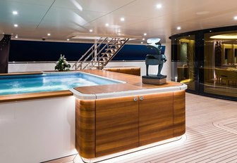 inviting swimming pool on the aft deck of luxury yacht Here Comes The Sun