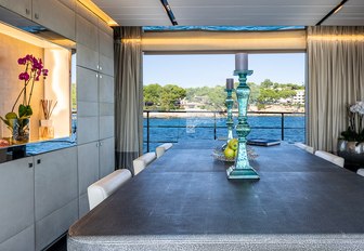 Covered dining table with doors open to balcony on motor yacht Cinquanta 50