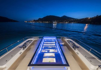 A swimming pool lit up at night on board a superyacht