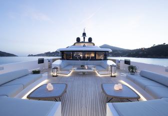 the spacious and minimalist sundeck on superyacht lady lena with a breathtaking view of the Mediterranean surroundings while guests enjoy their charter vacation in summer 2020 