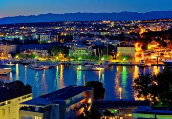 Croatian marina glowing with lights at night time