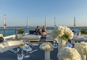 guests relax on seating aboard sundeck of charter yacht ROMA