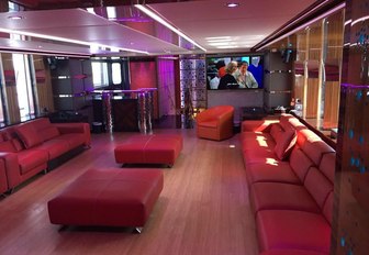 red leather seating illuminated by colourful lighting in the skylounge aboard charter yacht Code 8