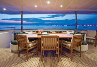 alfresco dining aboard superyacht ‘One More Toy’ as sun sets over the horizon