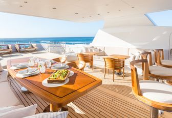 bar, seating area and sun pads on the sundeck of motor yacht HANIKON 