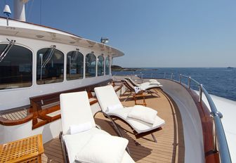 sun loungers are laid out on the wide side deck of luxury yacht SHERAKHAN