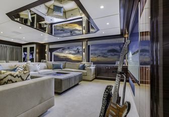 cinema area with vintage guitar in skylounge of charter yacht ‘King Baby’ 