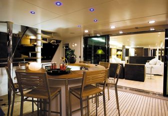 circular teak bar on main aft deck of superyacht LIONSHARE 