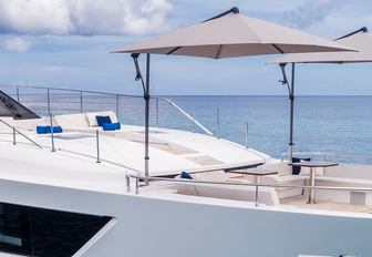 seating and tables with shade on the foredeck of charter yacht Vista Blue