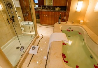 bath filled with rose petals in the master en suite aboard charter yacht ‘Chasing Daylight’