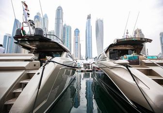 two yachts lined up for the Dubai International Boat Show with skyline in background