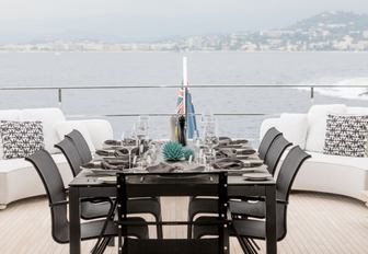 al fresco dining table on the upper deck aft of luxury yacht December Six 