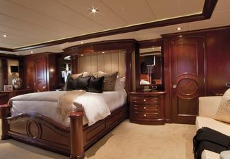 luxury yacht alessandra owner's cabin, with mahogany wall panels and cream accents