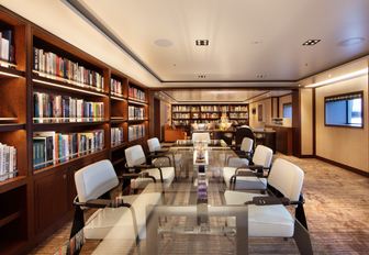 long table in conference room of luxury yacht planet nine, with bookshelves on wall
