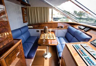 a chess set sits in between two blow loungers inside the classically flydeck on charter yacht WISH