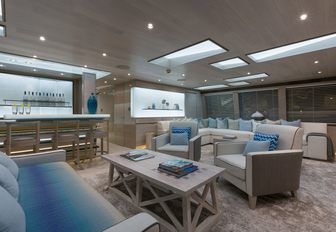 white-washed skylounge with sofas and bar on board charter yacht THUMPER 