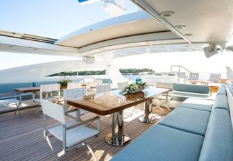 casual alfresco dining area on sundeck of luxury yacht VICTORY