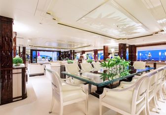 glass topped table forms formal dining area in main salon of charter yacht ‘Lioness V’ 