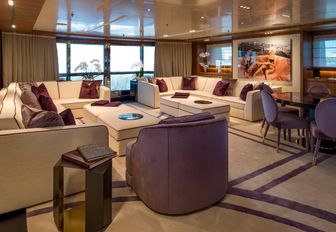 large sofas create a social seating area in the skylounge aboard charter yacht RARITY