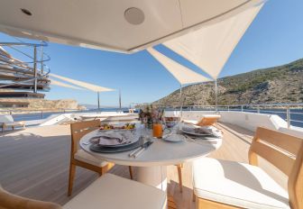 An alfresco dining set up onboard charter yacht PROJECT X