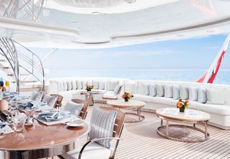 seating area on aft deck of amels charter yacht lady e, with al fresco dining in foreground