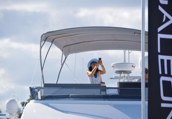 visitor at FLIBS takes a picture for the deck of a yacht exhibiting at FLIBS