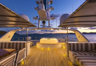 sundeck on board charter yacht SILENTWORLD with sunning and seating areas lights up at night